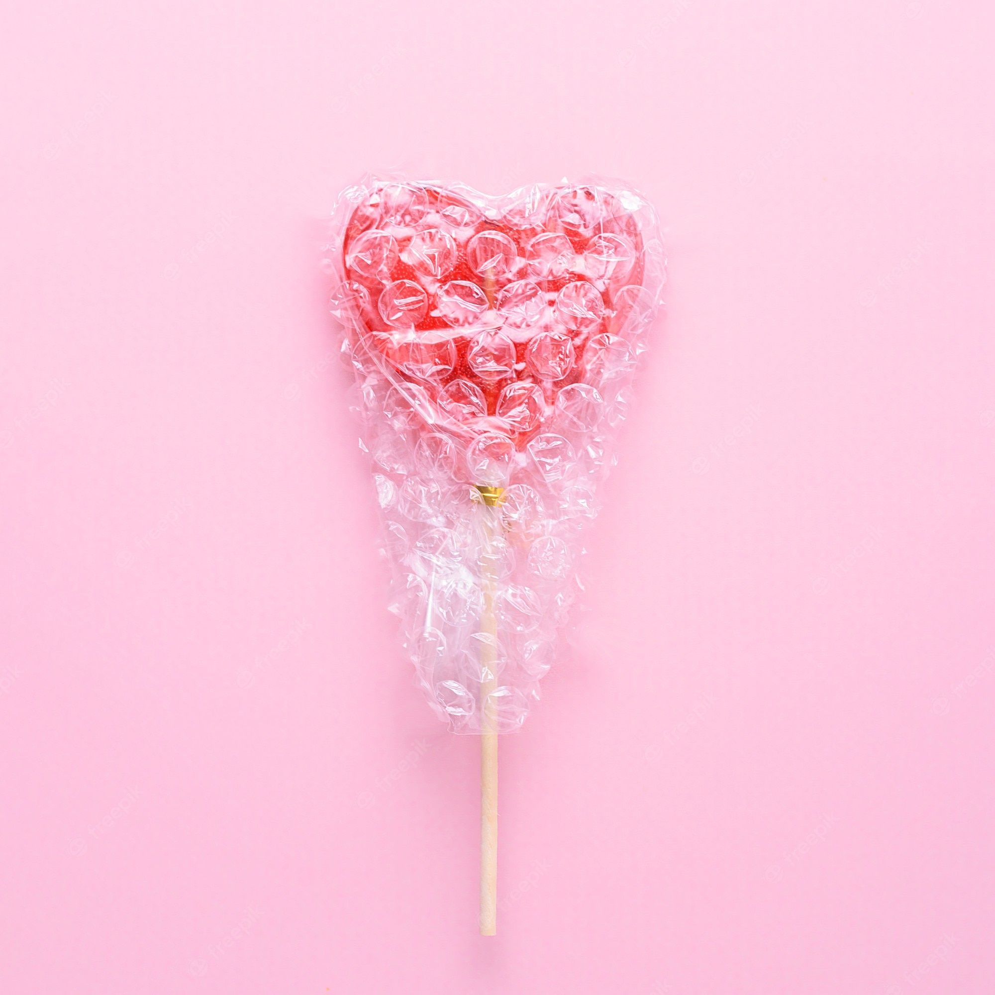 Premium Photo. Creative Mental Health Concept. Single Heart Shaped Lollipop Wrapped In Bubblegum On A Pink Background