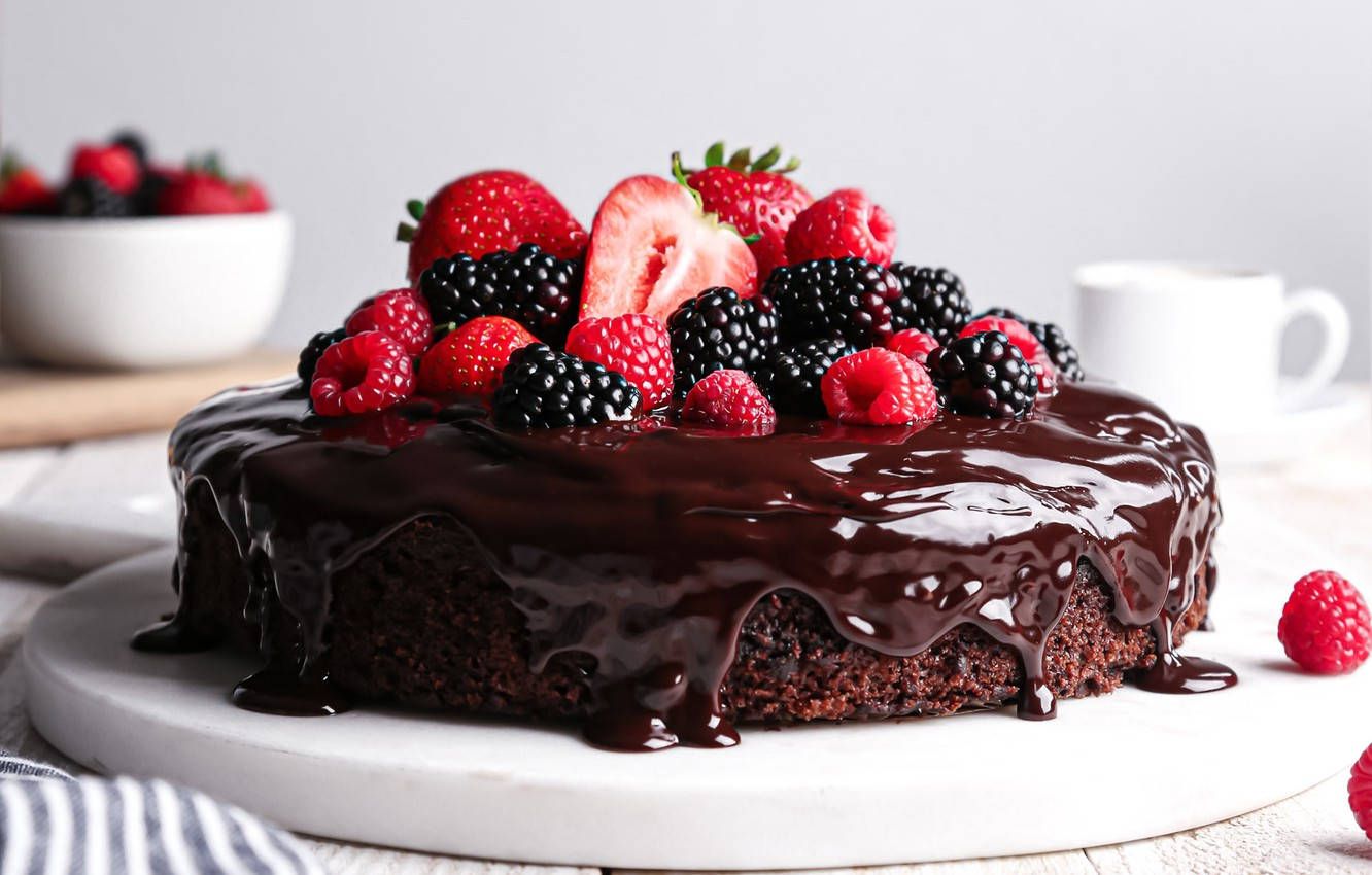 A chocolate cake with berries and whipped cream - Cake