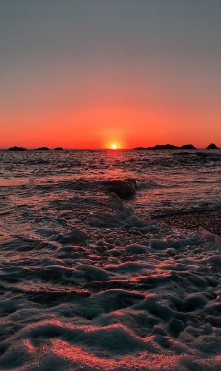The sun sets over a calm ocean - Sunrise