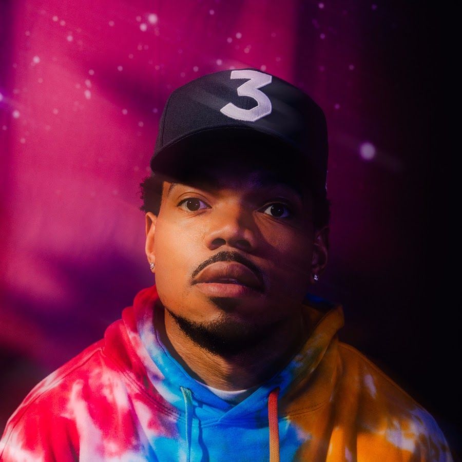 A man wearing tie dye clothing and hat - Chance the Rapper