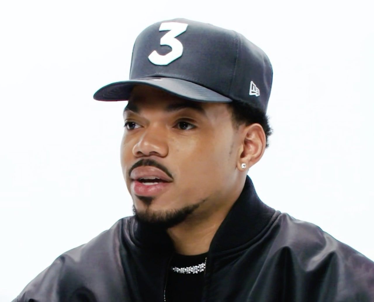 Chance the Rapper wearing a hat and looking into the camera. - Chance the Rapper