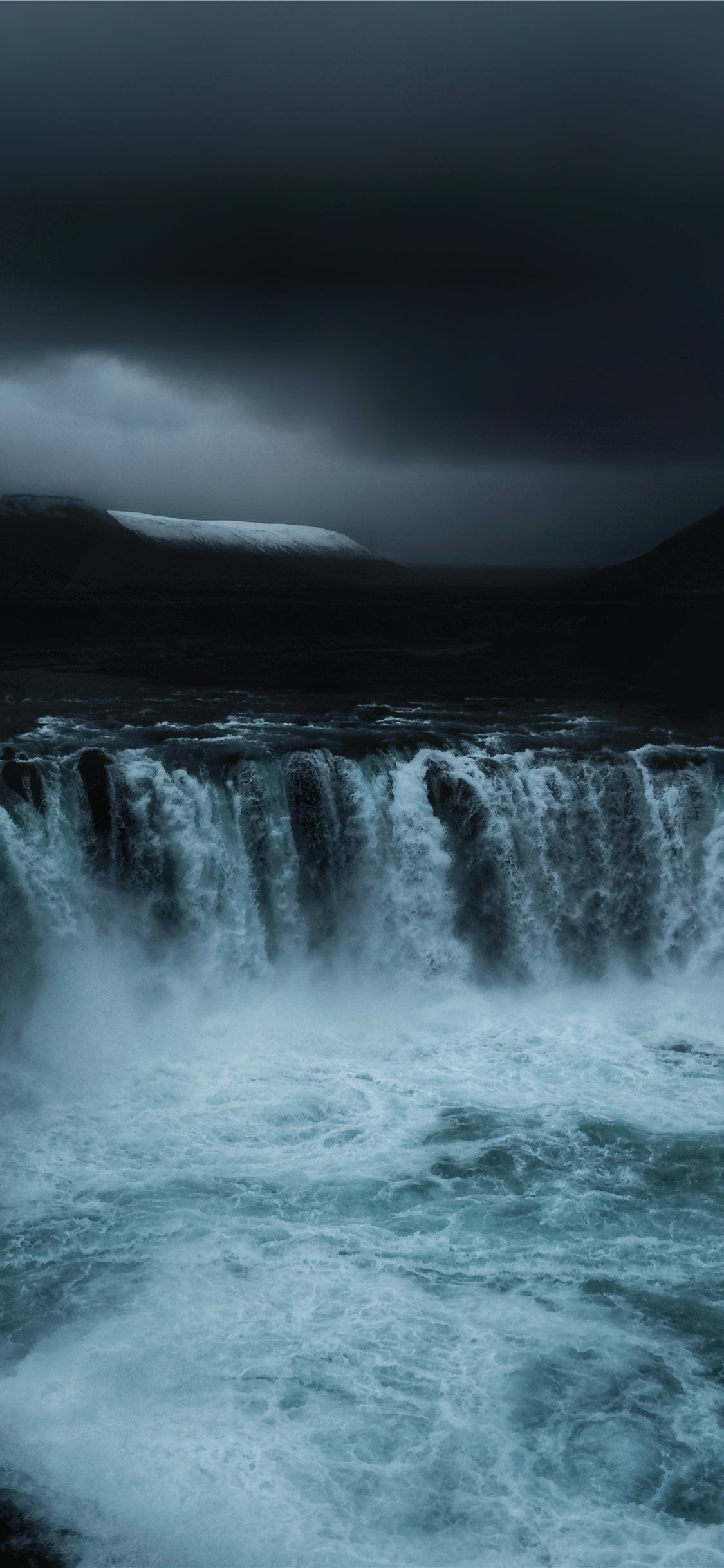 IPhone wallpaper of a waterfall with a dark sky - Waterfall