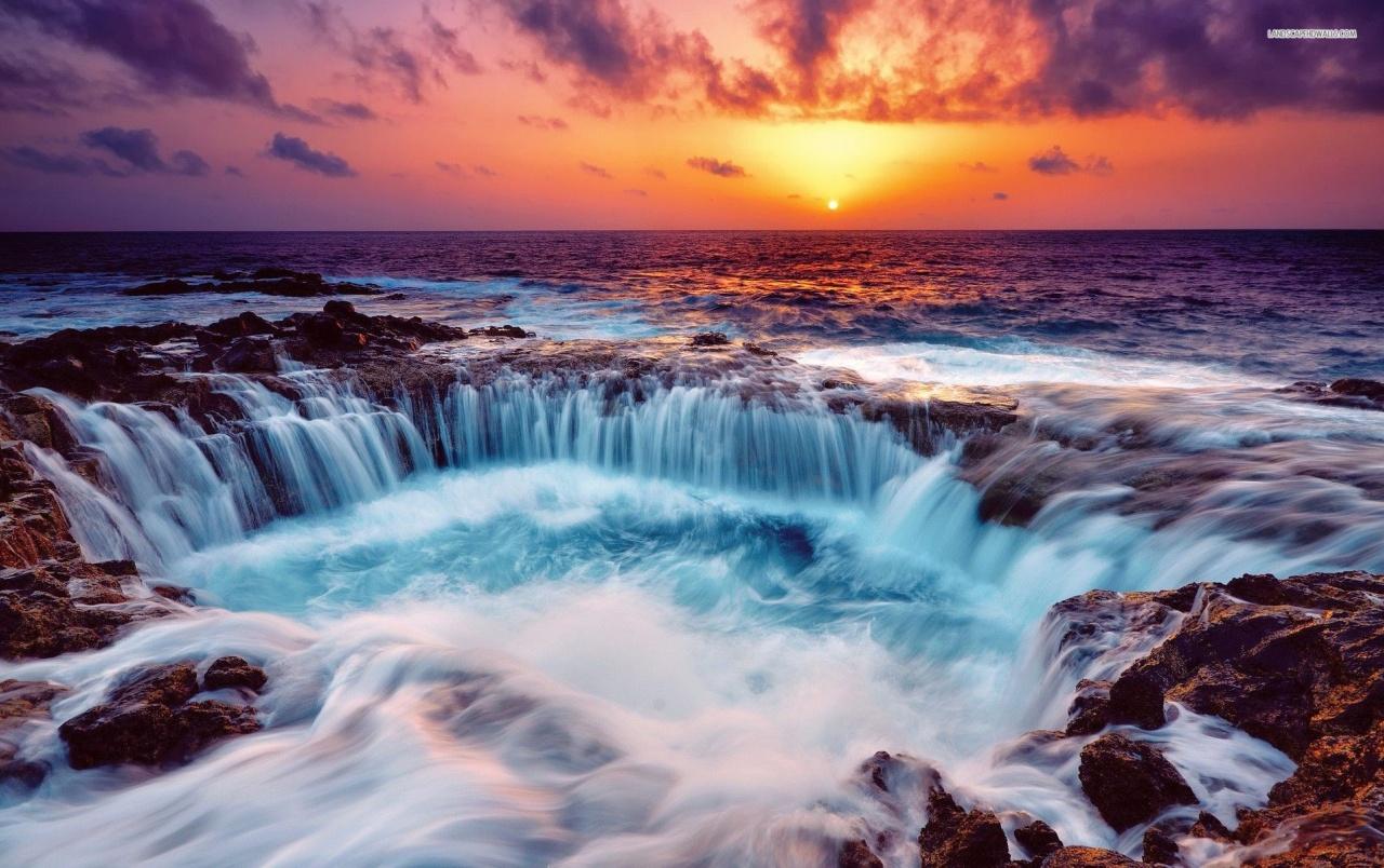 A waterfall is flowing into the ocean - Waterfall