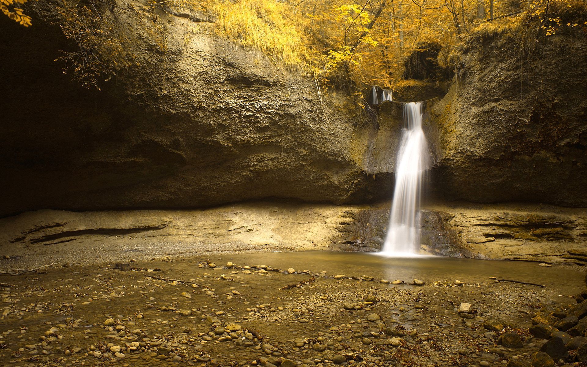 A waterfall in the middle of some trees - Waterfall