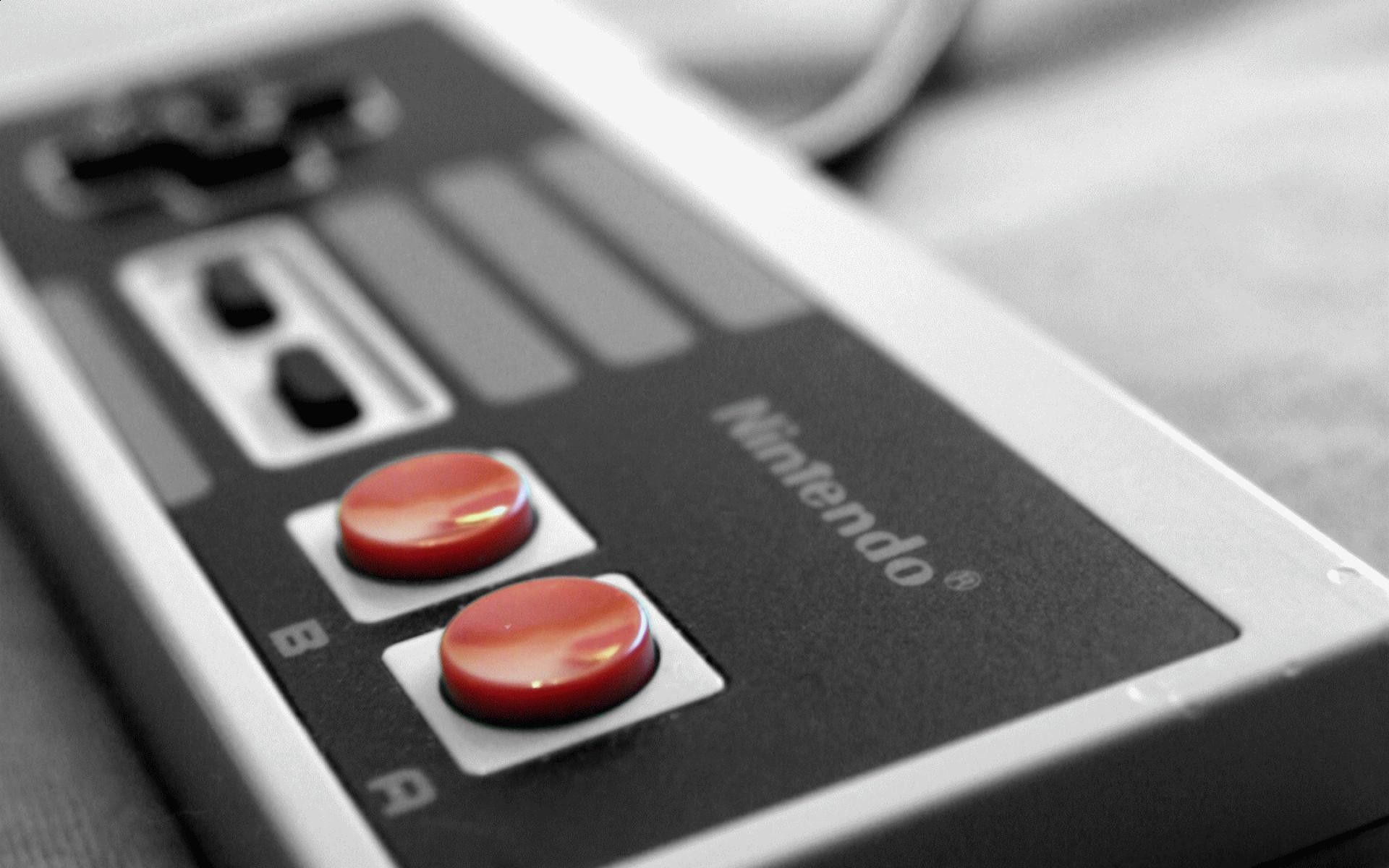 A Nintendo game controller with two red buttons. - Nintendo