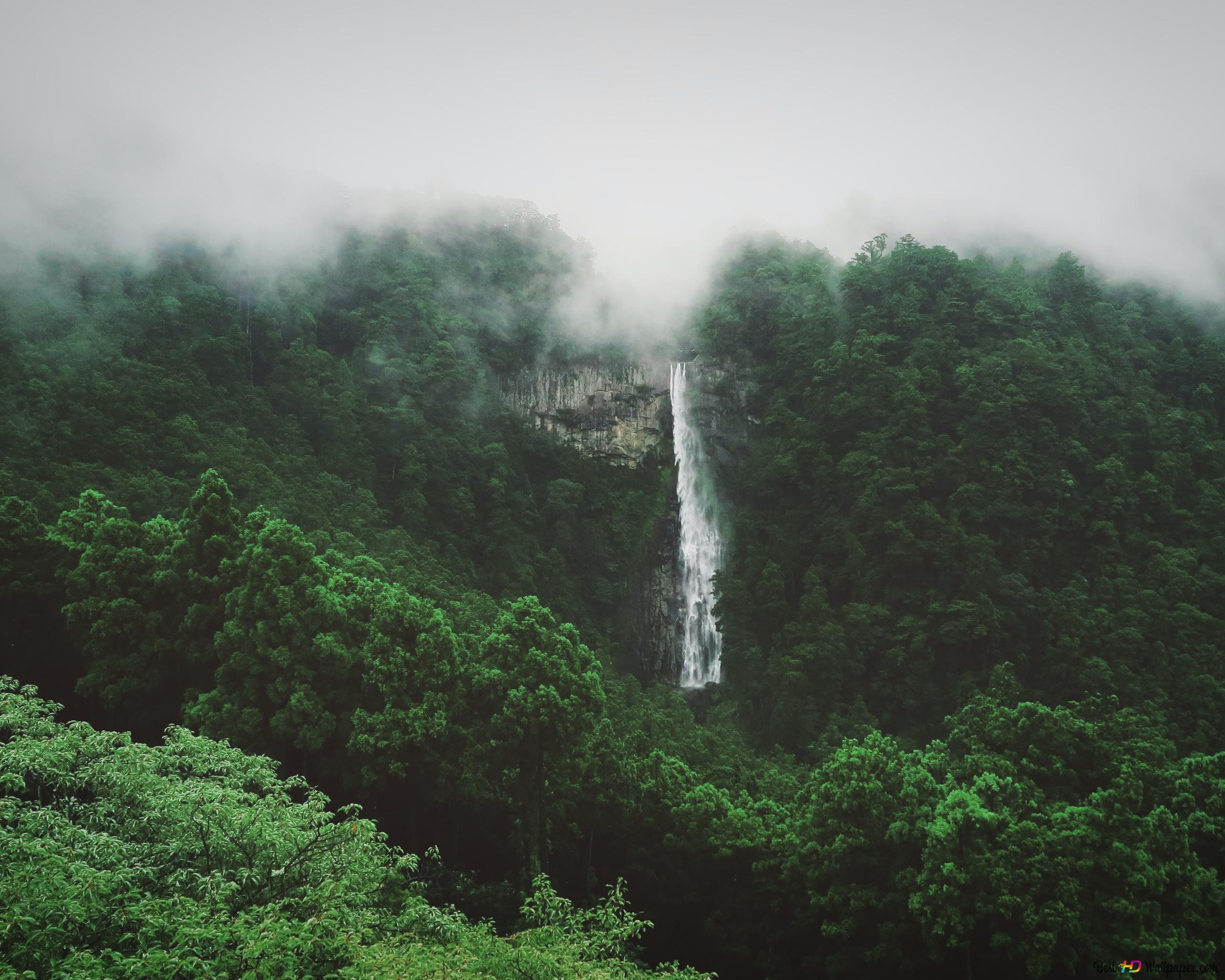 The beauty of the waterfall flowinguds over the mountains 4K wallpaper download