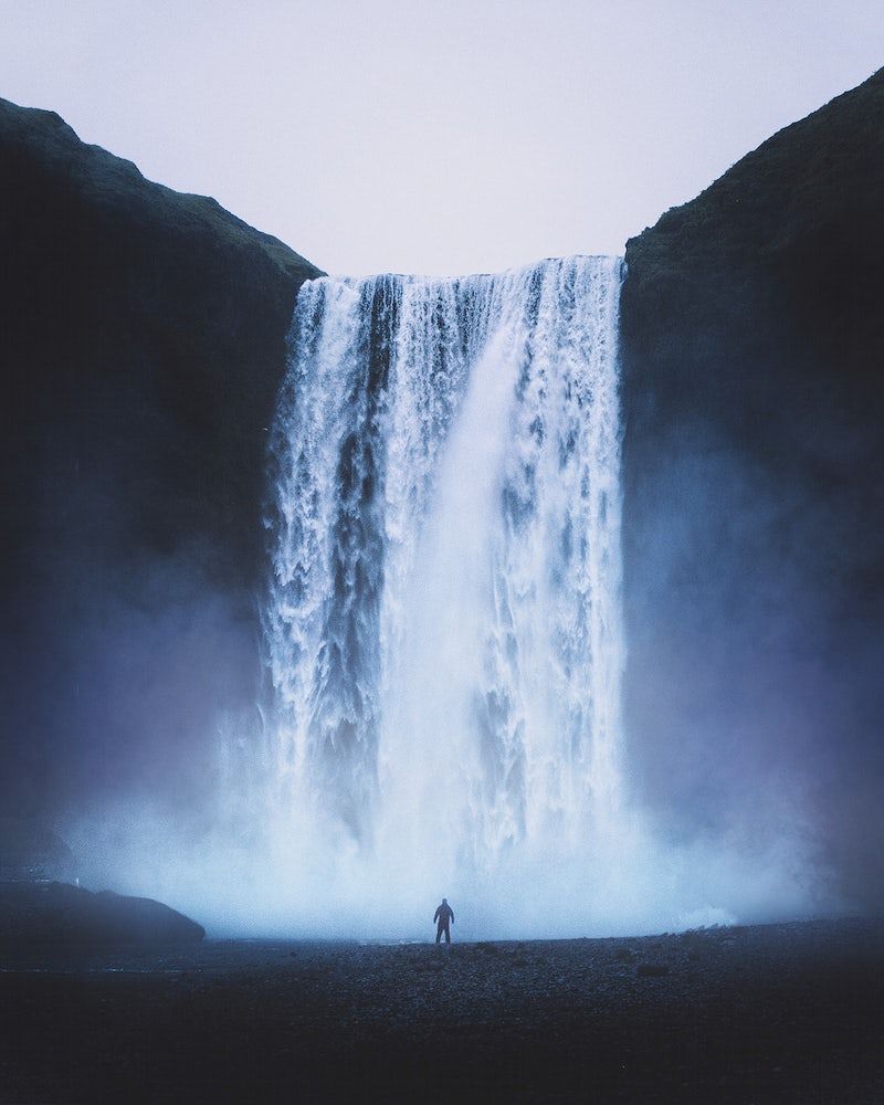 A man standing in front of waterfall - Waterfall