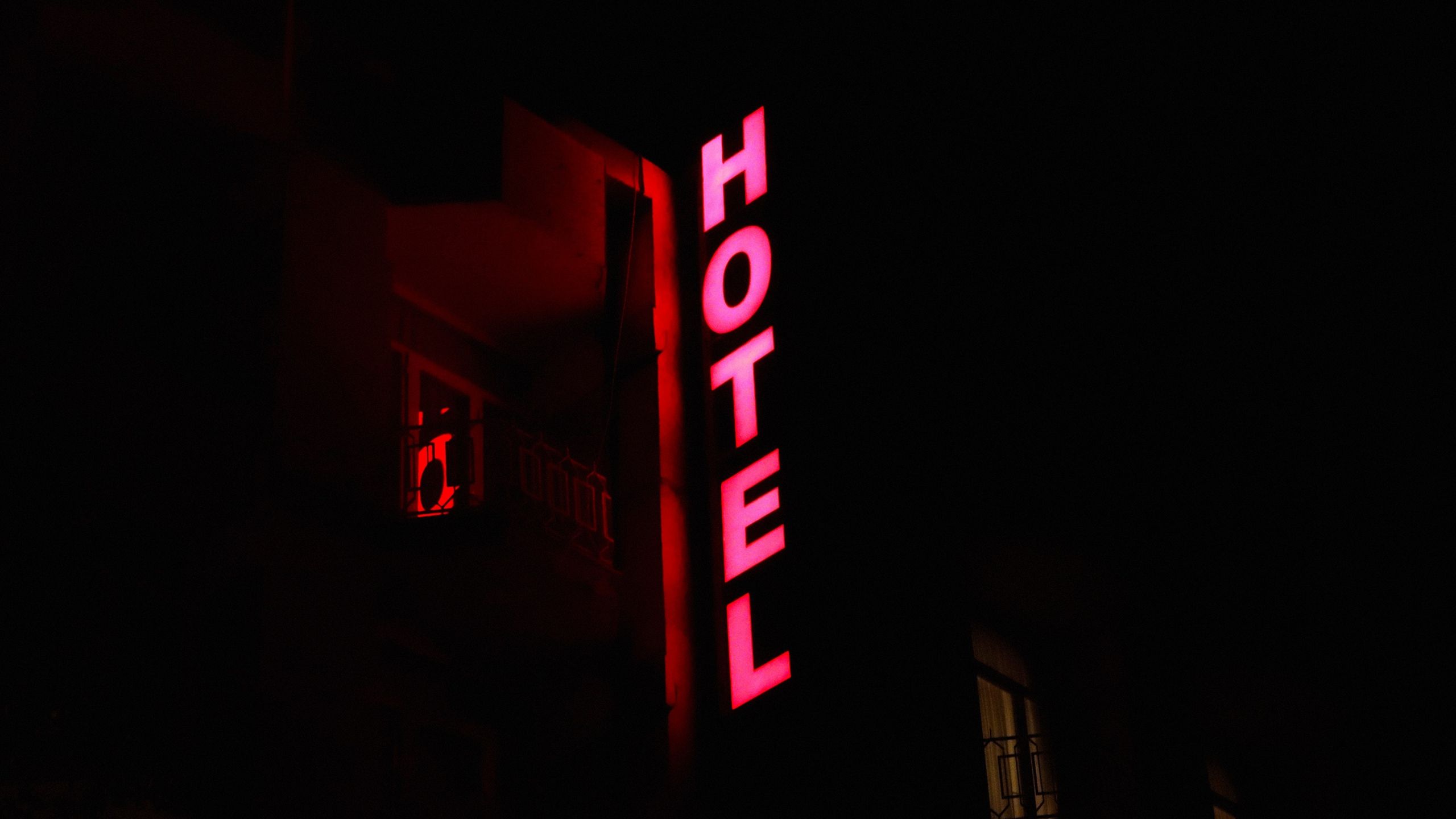 A hotel sign that is lit up at night - YouTube