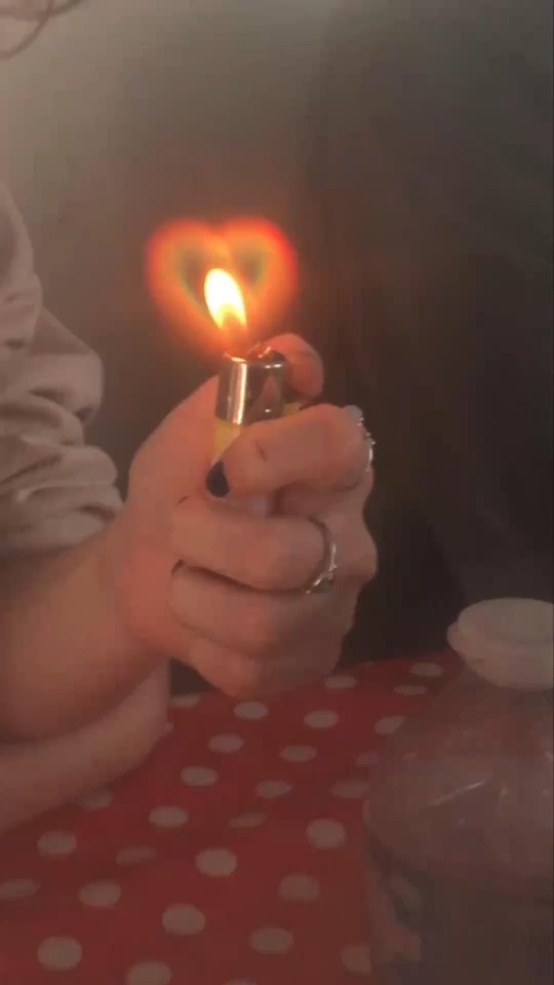 A person holding a lit lighter - Lovecore