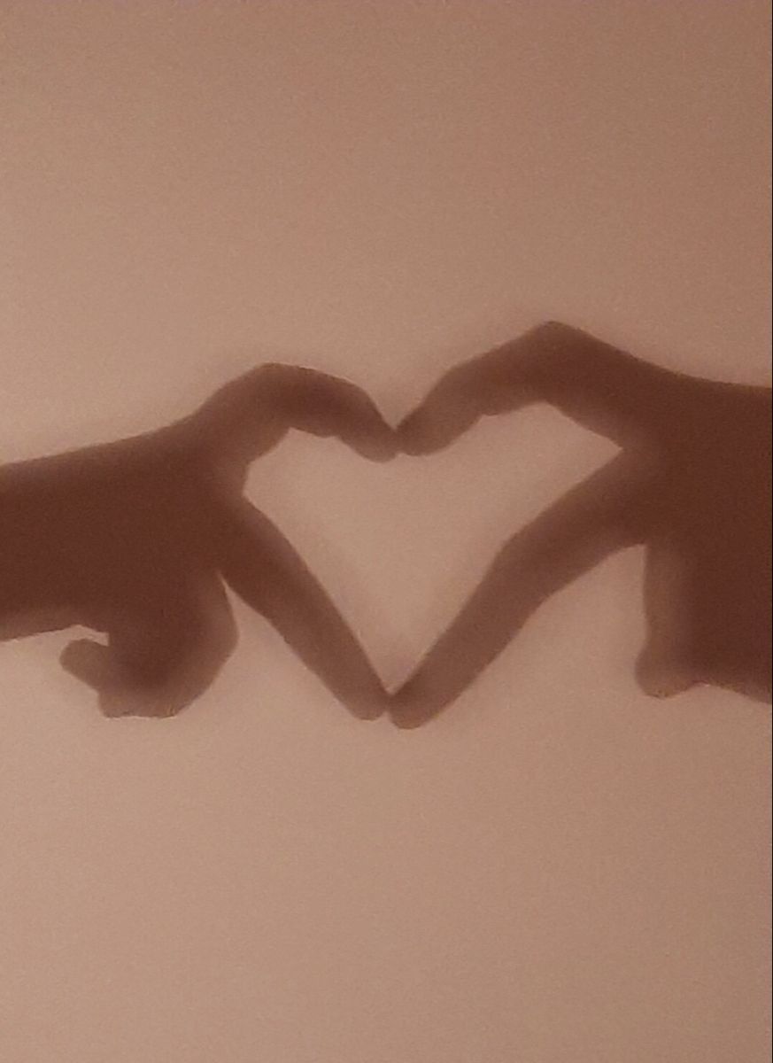 Two hands making a heart shape against a wall - Lovecore