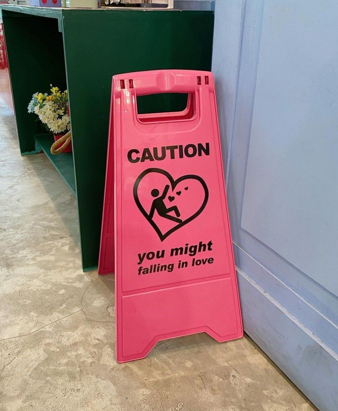 A pink caution sign that says 