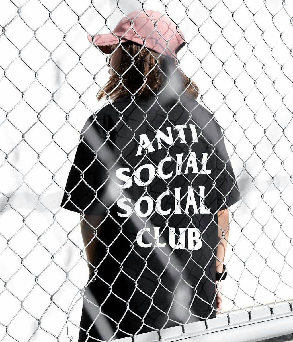 A woman wearing a black Anti Social Social Club t-shirt - Anti Social Social Club