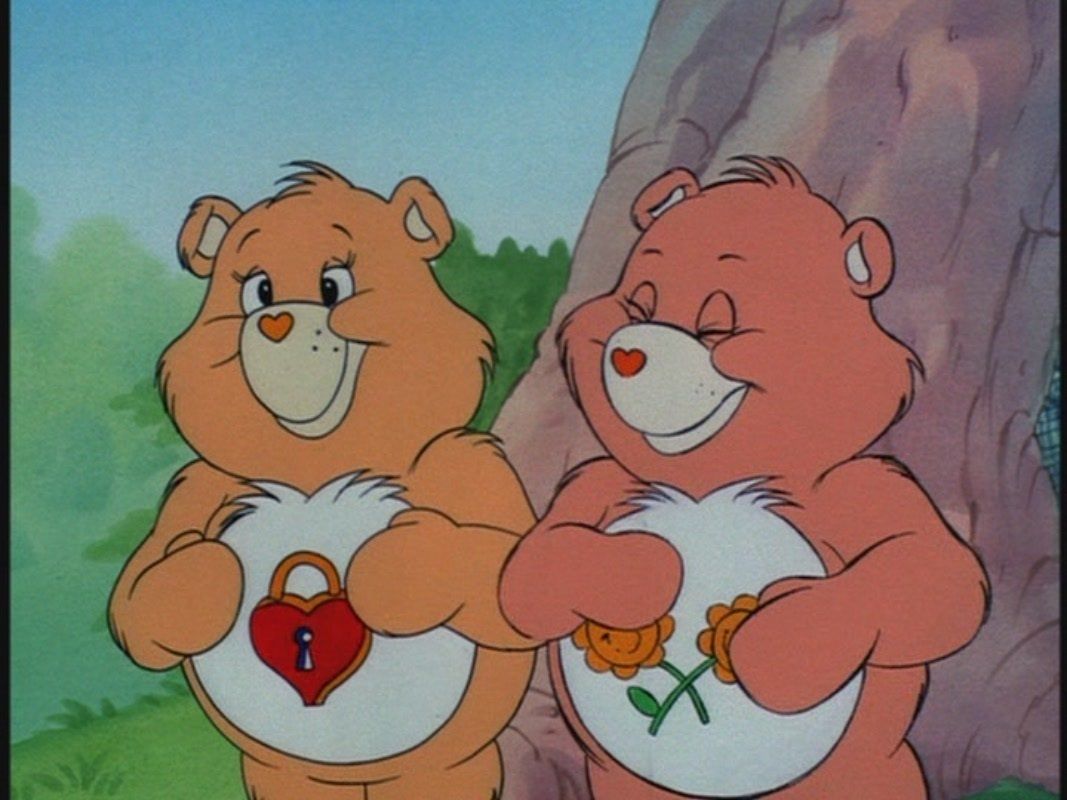 The two bears from the Care Bears show holding hearts on their bellies. - Care Bears