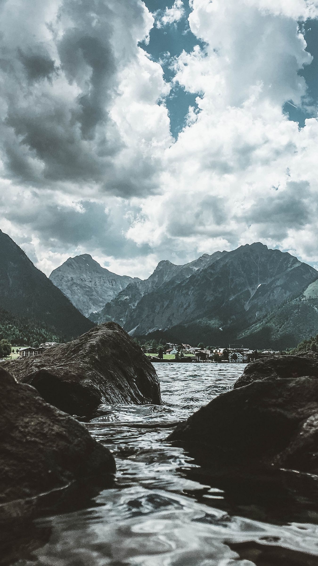 A body of water with rocks in it - River