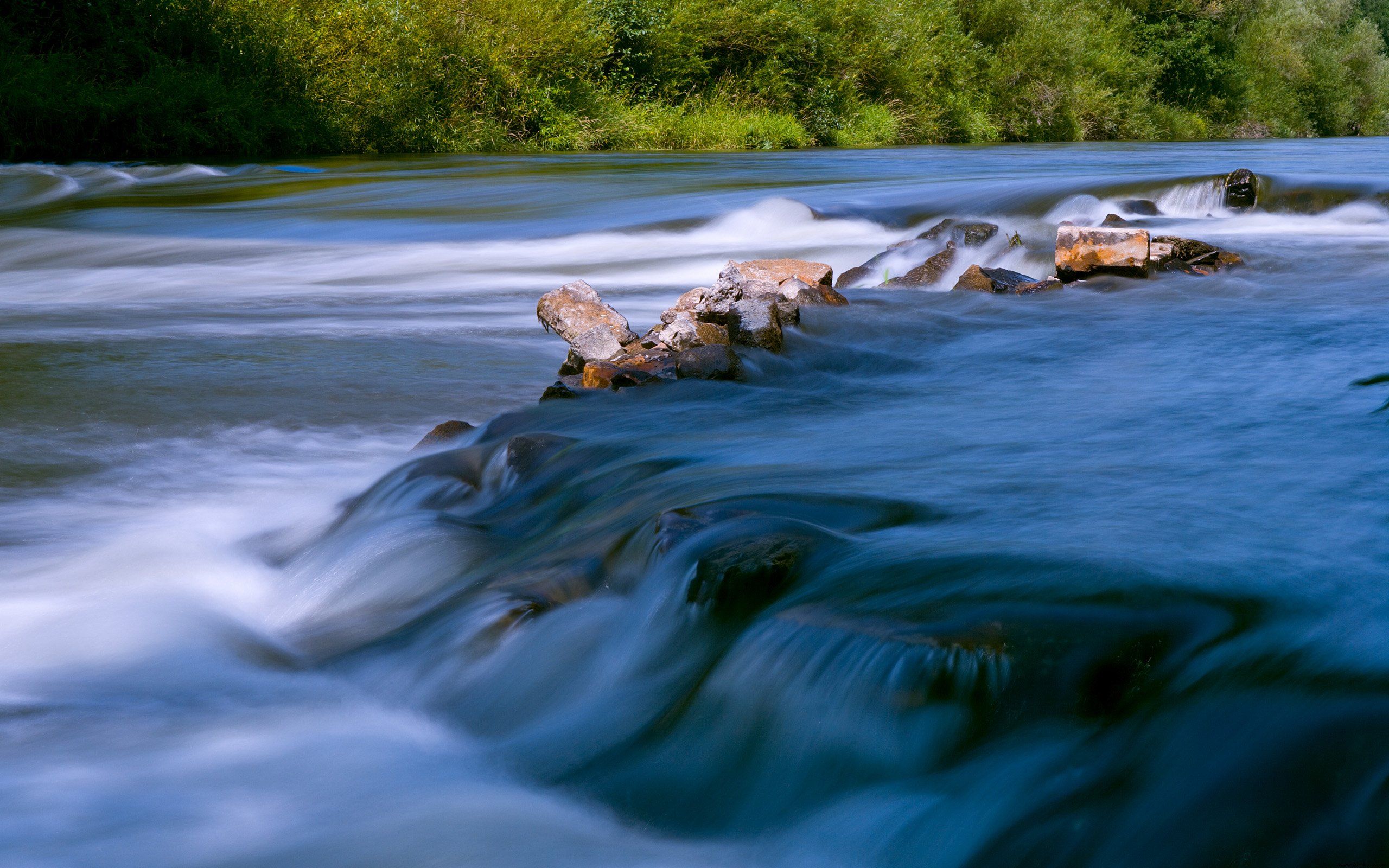 A river flows over rocks in a long exposure. - River