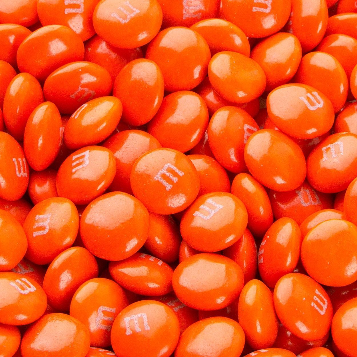A pile of orange M&M's - Chocolate, candy