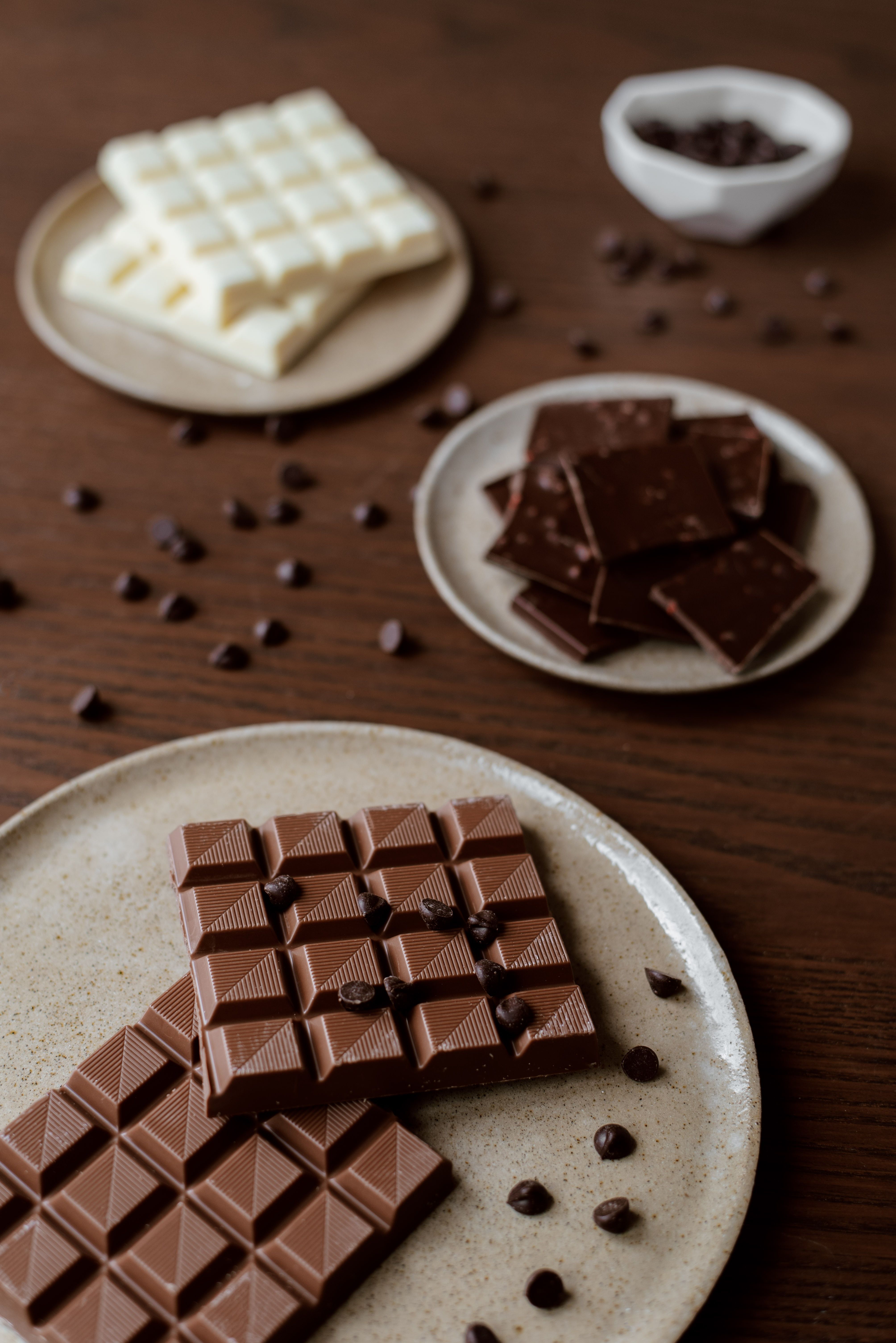 A plate of chocolate bars and some nuts - Chocolate