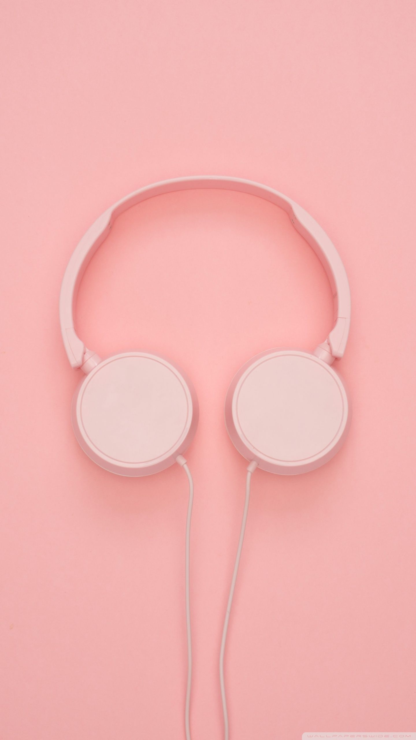 A pair of pink headphones on a pink background - Pink