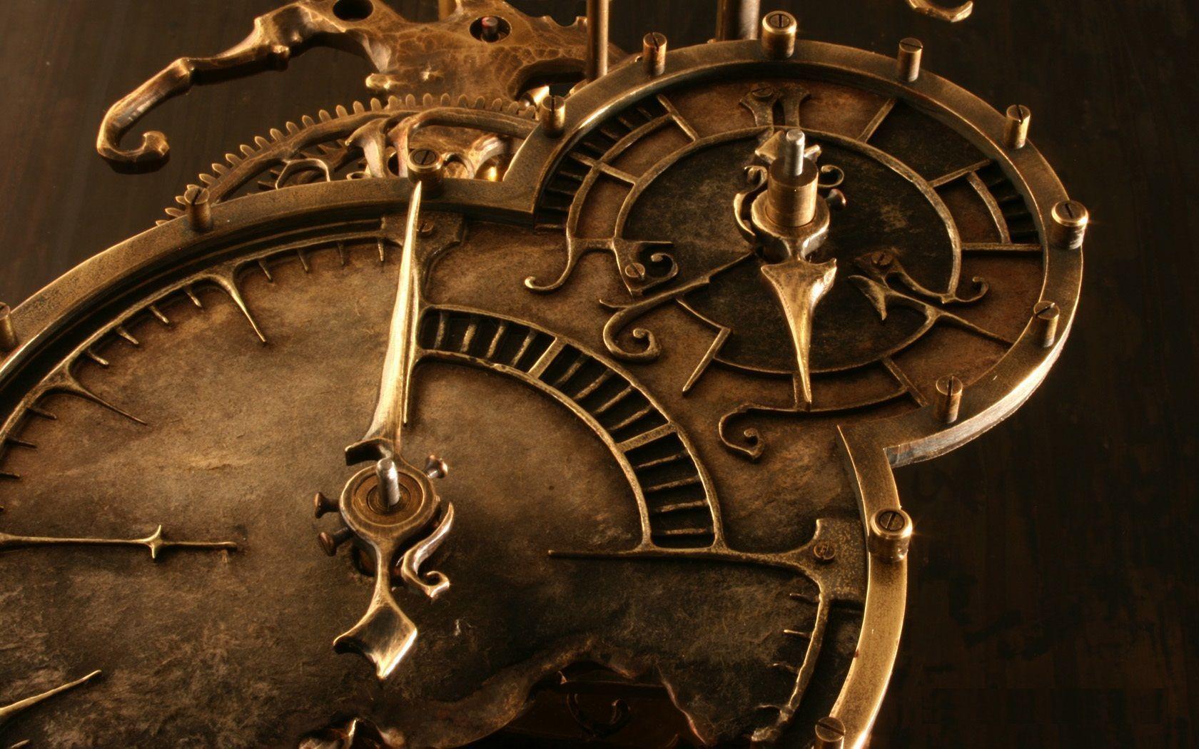 Close up of a brass clock with gears and dials. - Steampunk