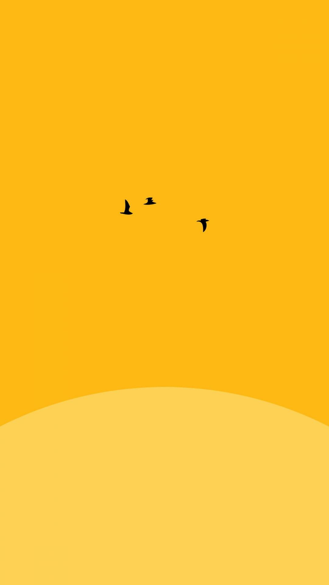 A yellow background with three birds flying in the sky - Yellow