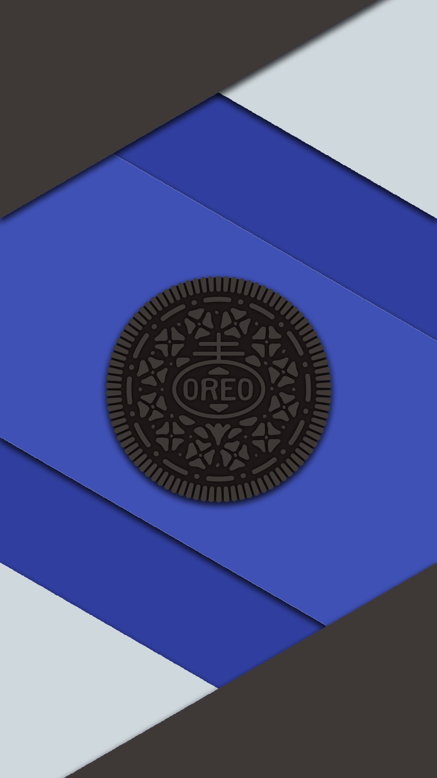 A photograph features a blue background with a white and black striped pattern. The image showcases a large cookie, specifically an Oreo, placed in - Oreo