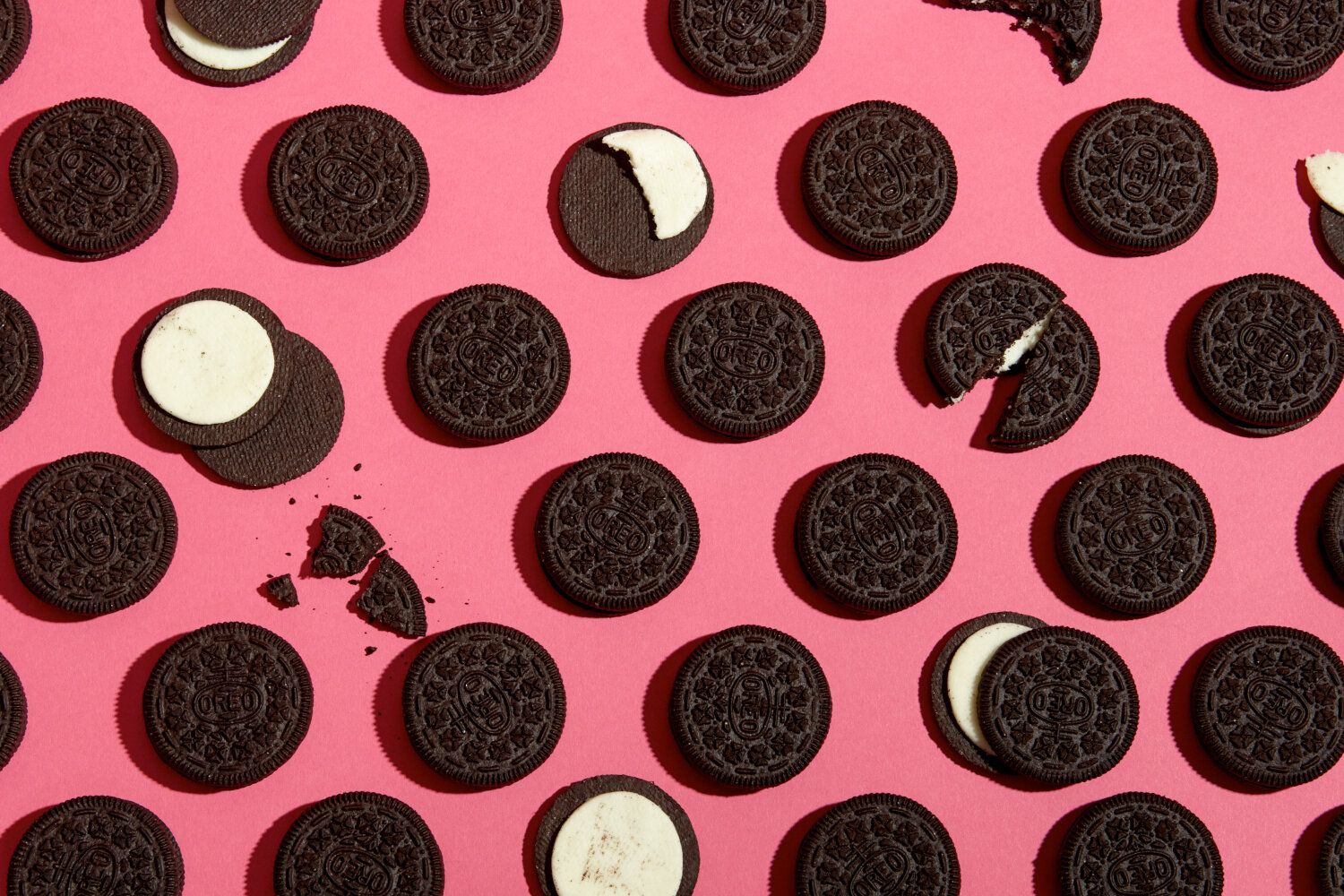 An overhead shot of Oreo cookies on a pink background. - Oreo
