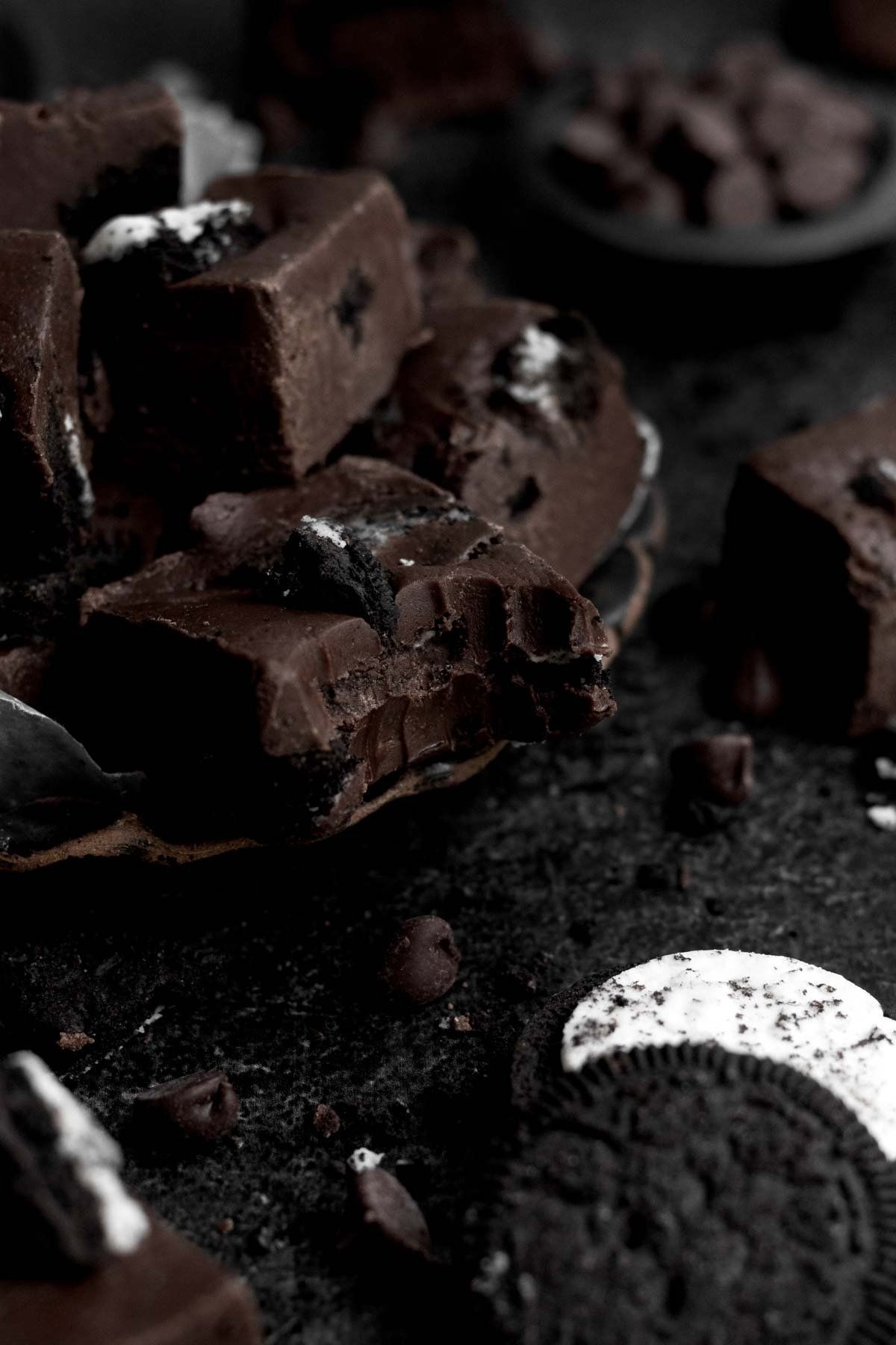 A close up of a piece of Oreo fudge with a spoonful taken out of it. - Oreo