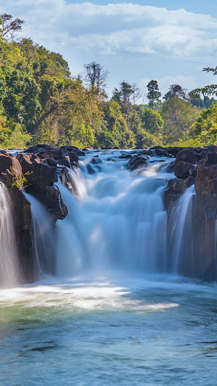 A waterfall surrounded by trees - Waterfall