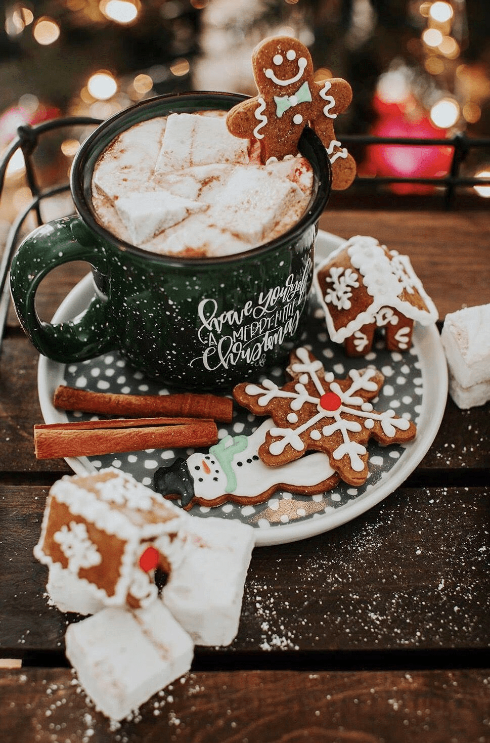 A cup of hot chocolate with marshmallows and gingerbread men. - Marshmallows