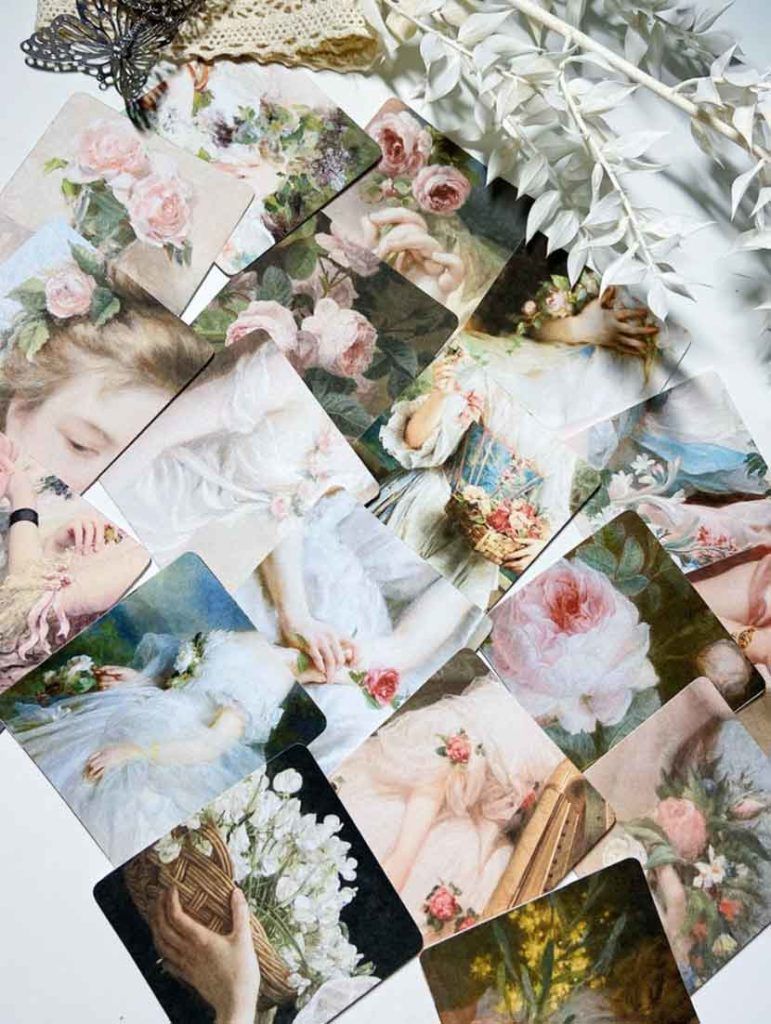 A collection of vintage floral postcards scattered on a table - Angelcore