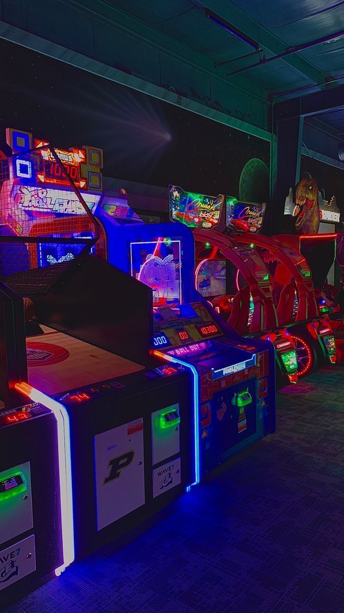 A group of people playing games in an arcade - Arcade