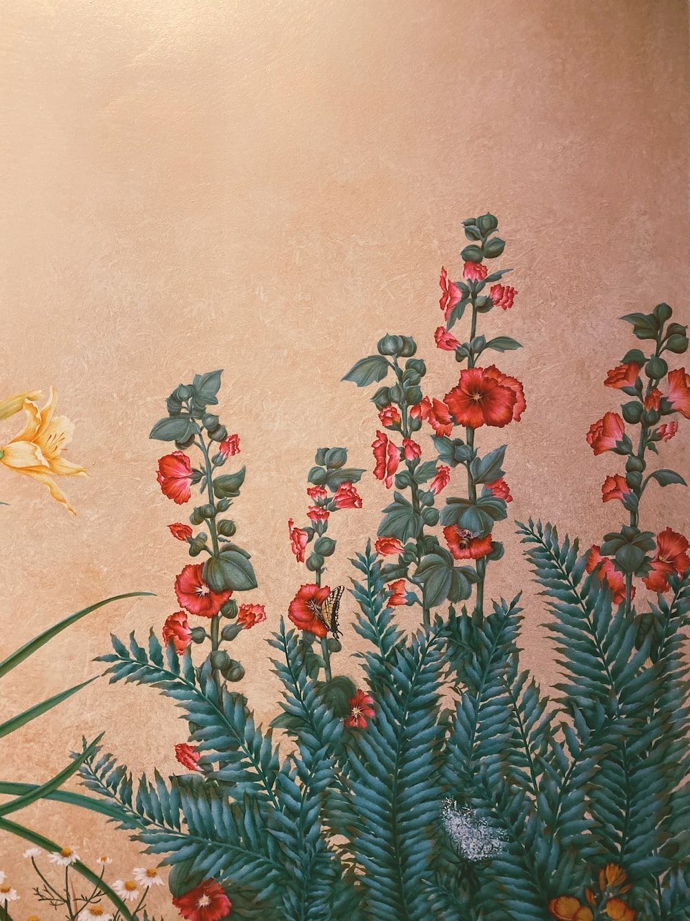 A detail of a painting with a gold background and flowers in the foreground. - Mexico