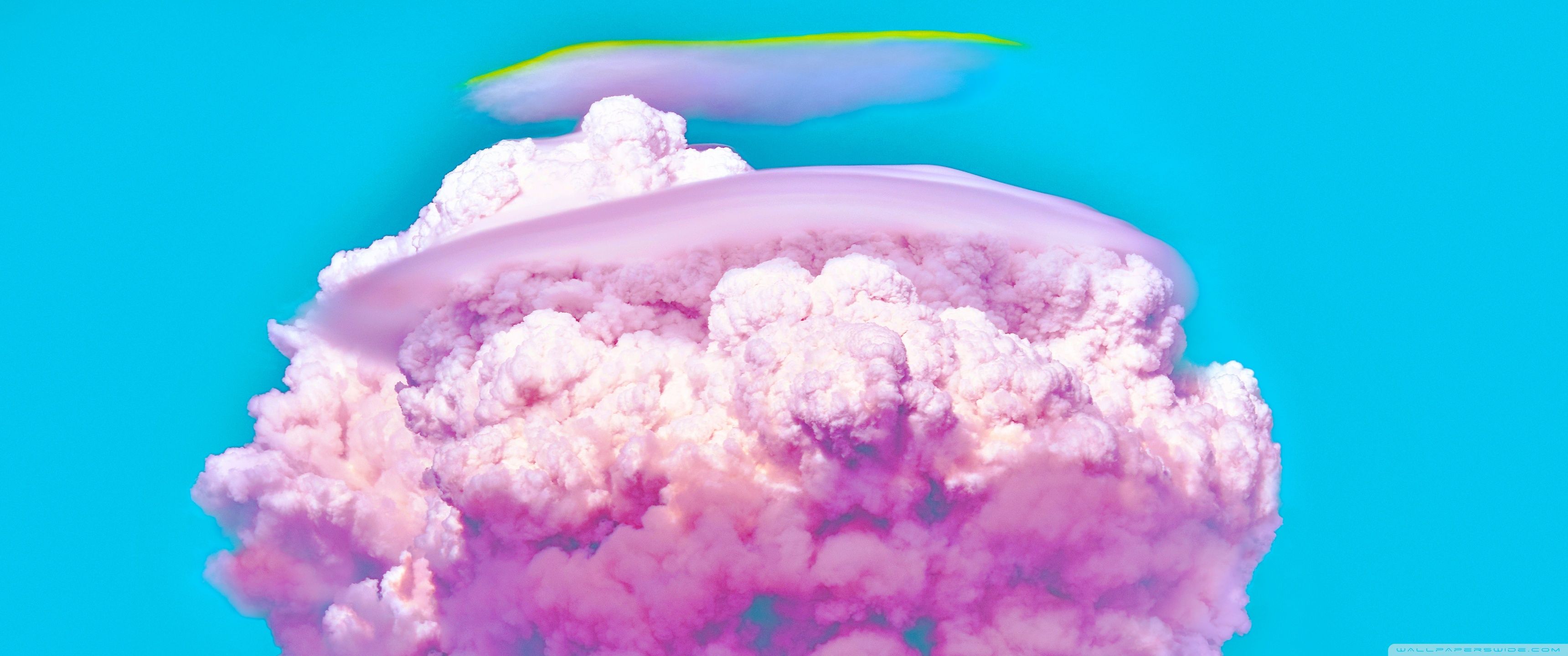 A pink cloud with blue sky in the background - 3440x1440