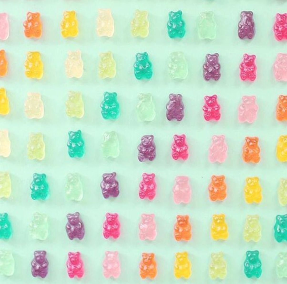 Gummy bears lined up on a blue background - Candy