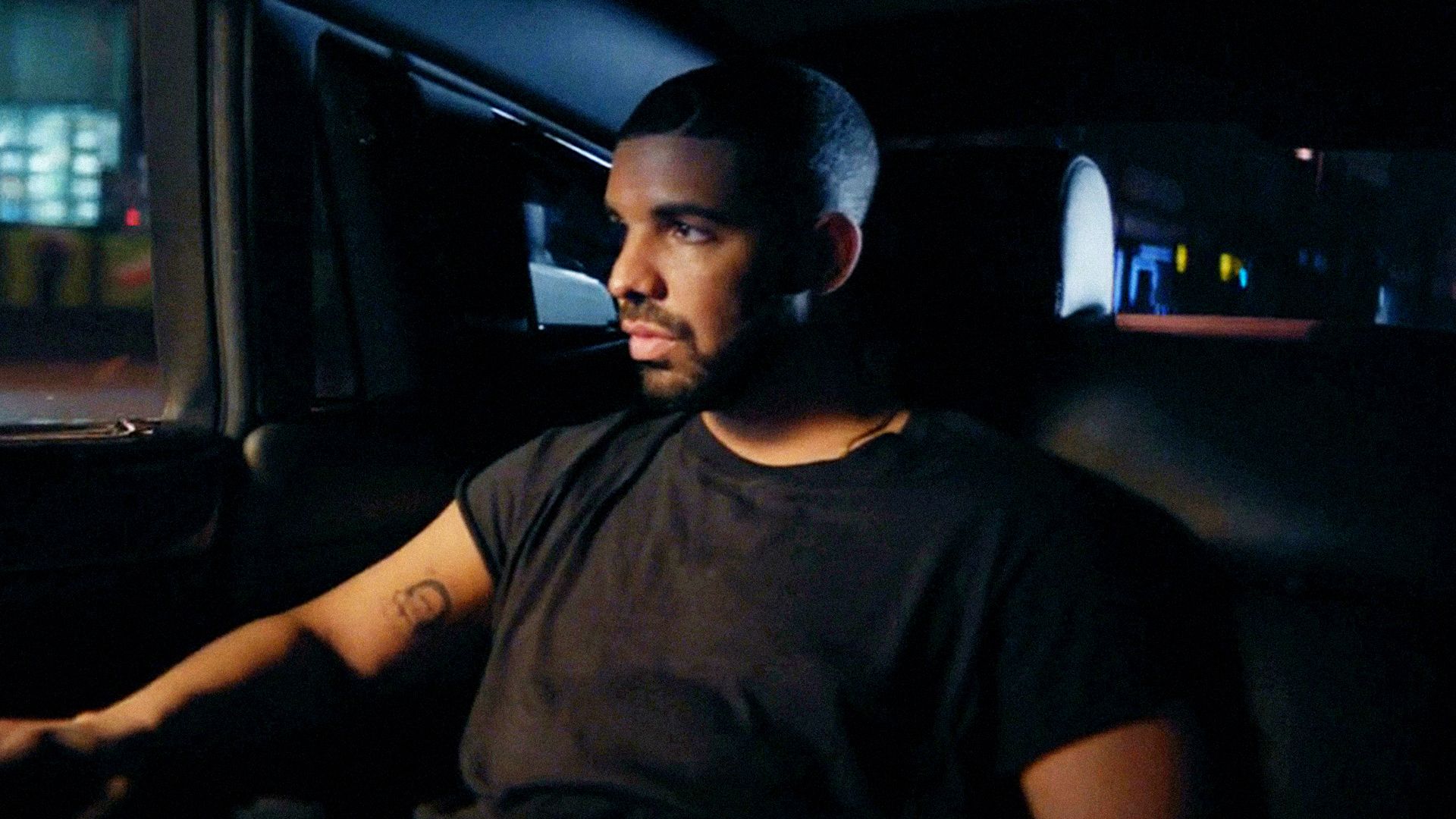 Drake sitting in the back of a car - Drake