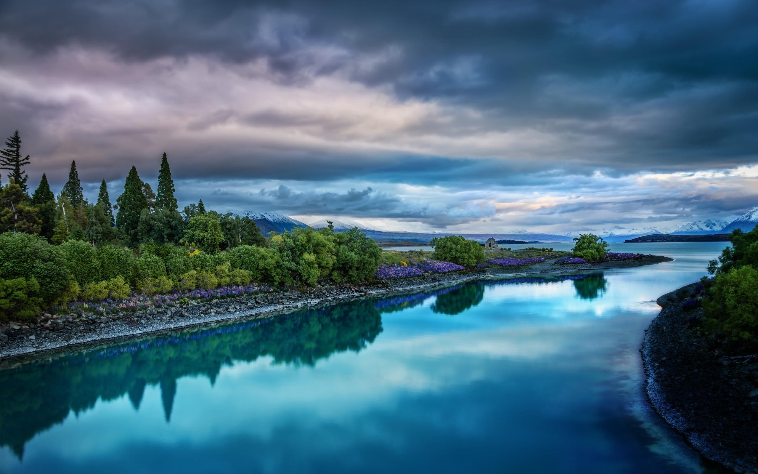 A river with trees and clouds in the background - River