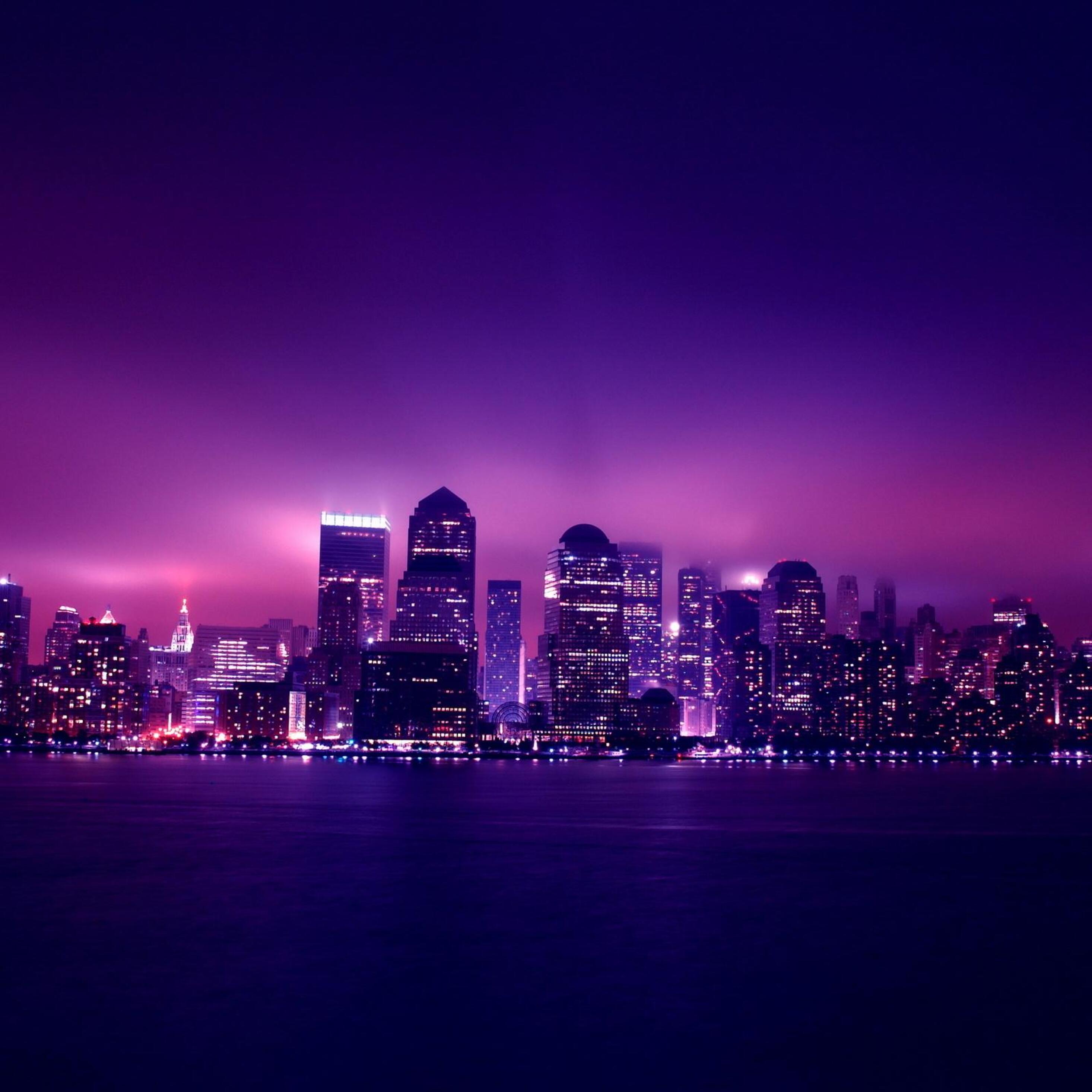 A purple and blue cityscape wallpaper with a purple sky - City