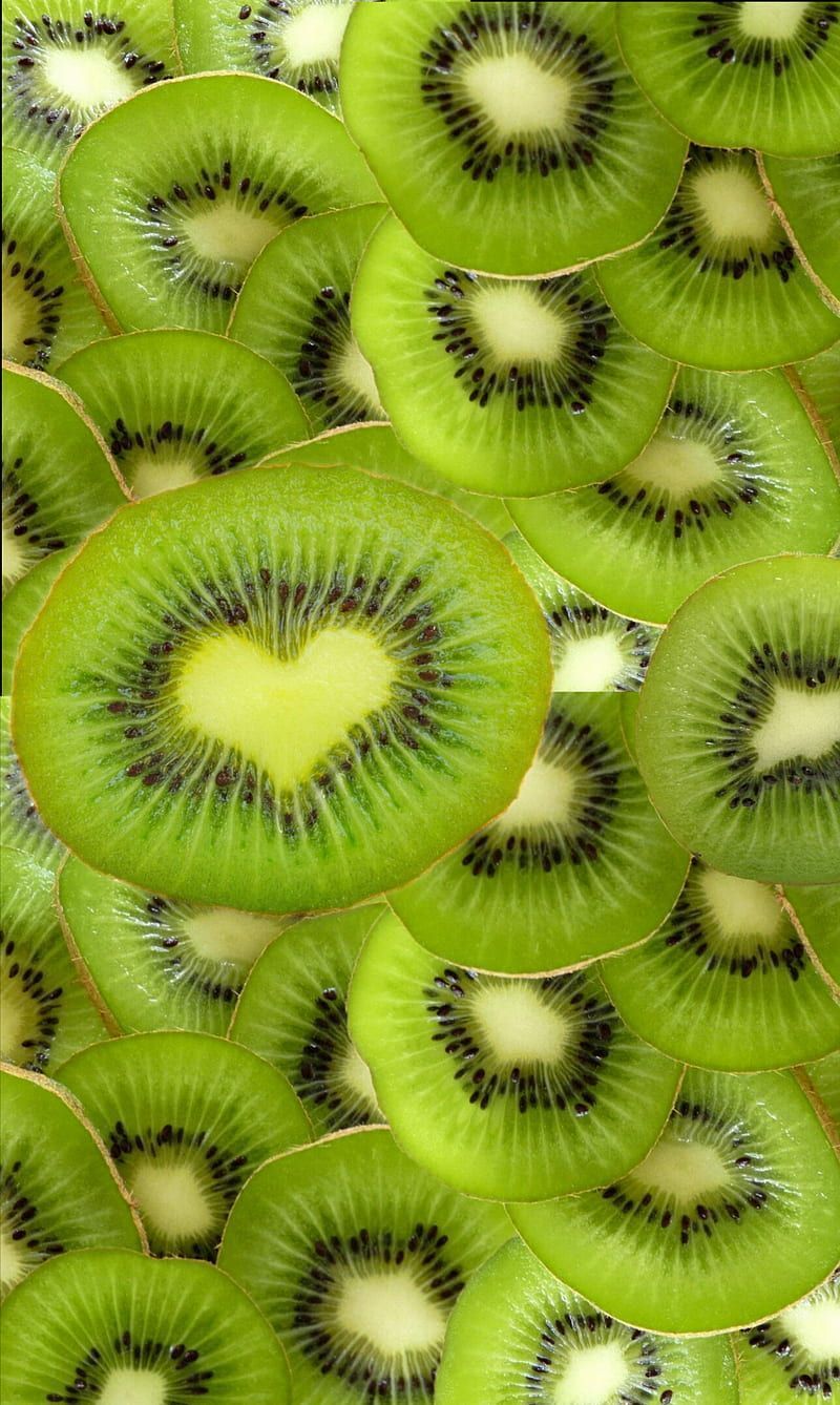 A background of kiwi slices, with a heart in the middle. - Kiwi