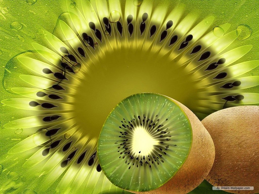 A kiwi fruit sliced in half on a green leaf background - Kiwi