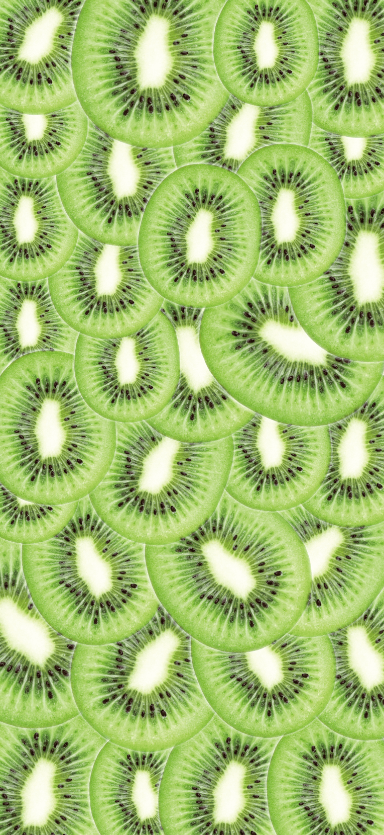 A close up of a pattern made from slices of kiwi fruit - Kiwi