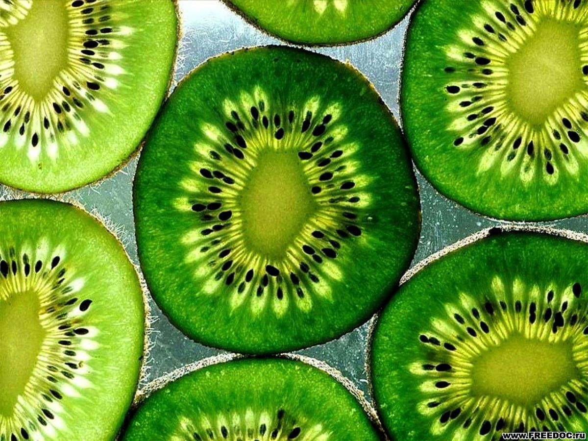 Kiwi slices on a glass table - Kiwi