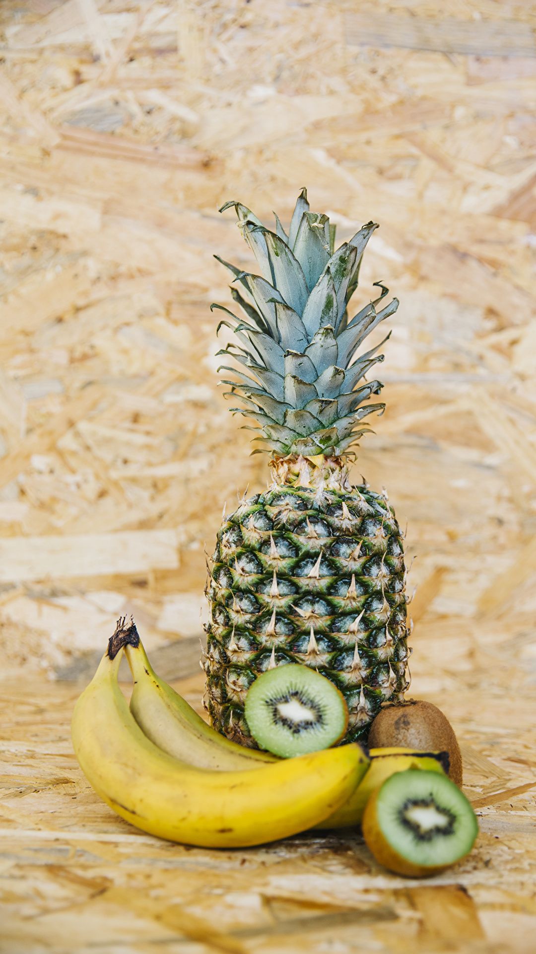 A pineapple, bananas and kiwi fruit on the table - Kiwi