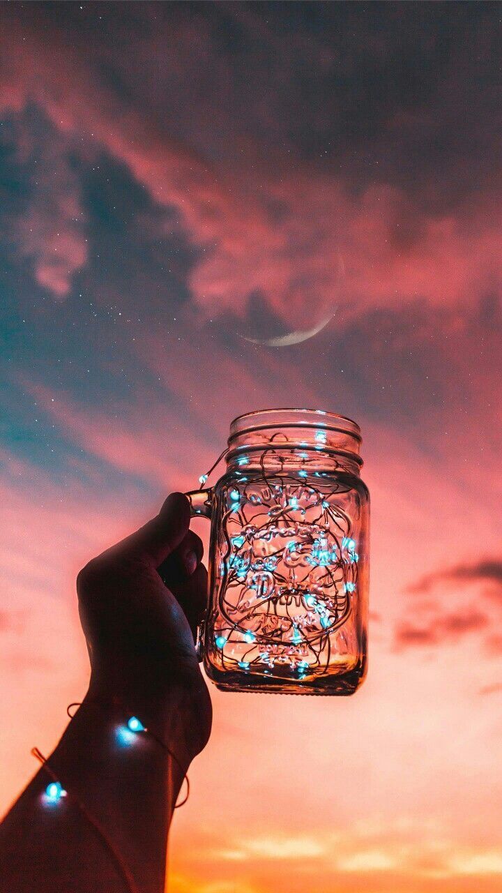 A hand holding a jar with lights in it - Android