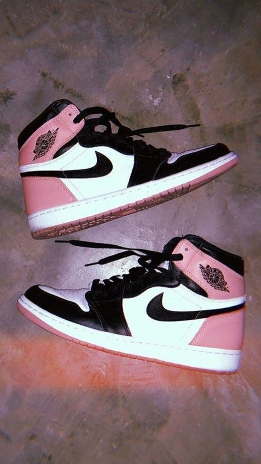A pair of pink and black Nike sneakers - Air Jordan