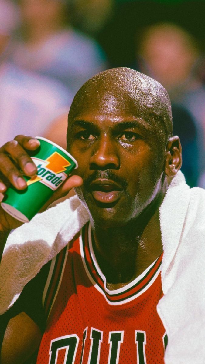 Michael Jordan drinks Gatorade during a break in a game. - Michael Jordan