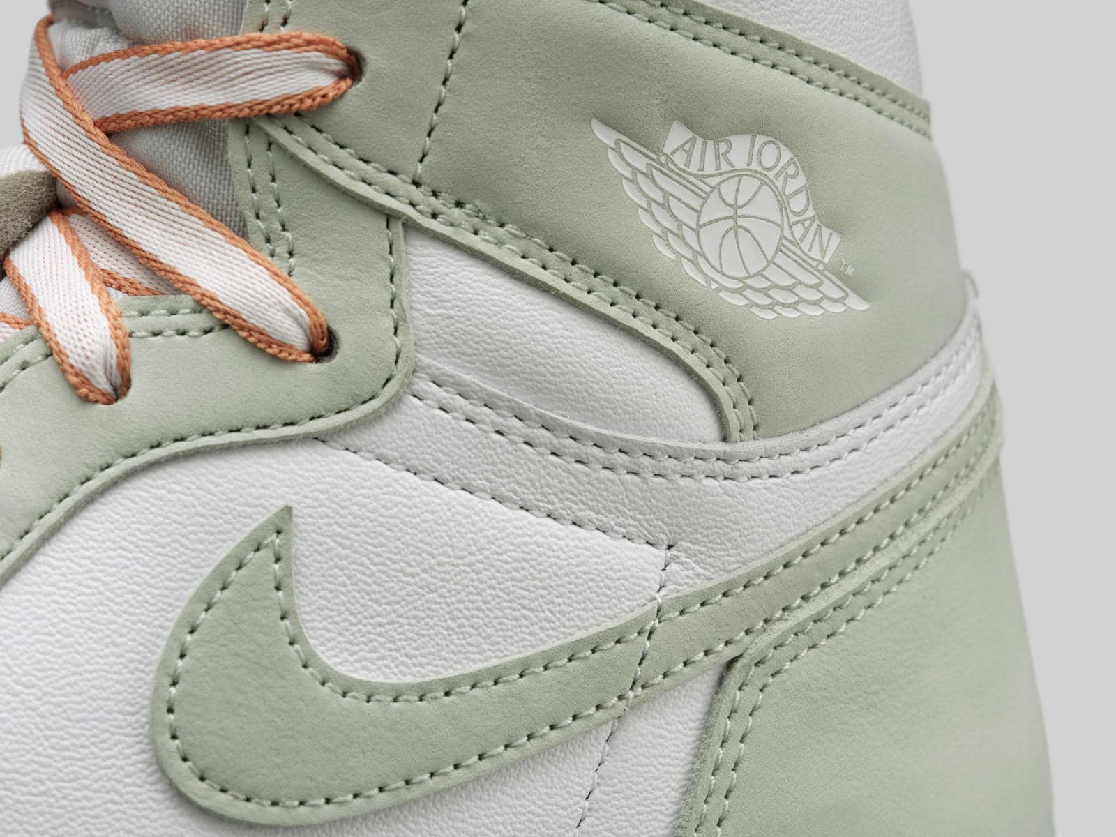 The heel of a pair of Jordan 1 shoes in a pale green color. - Air Jordan