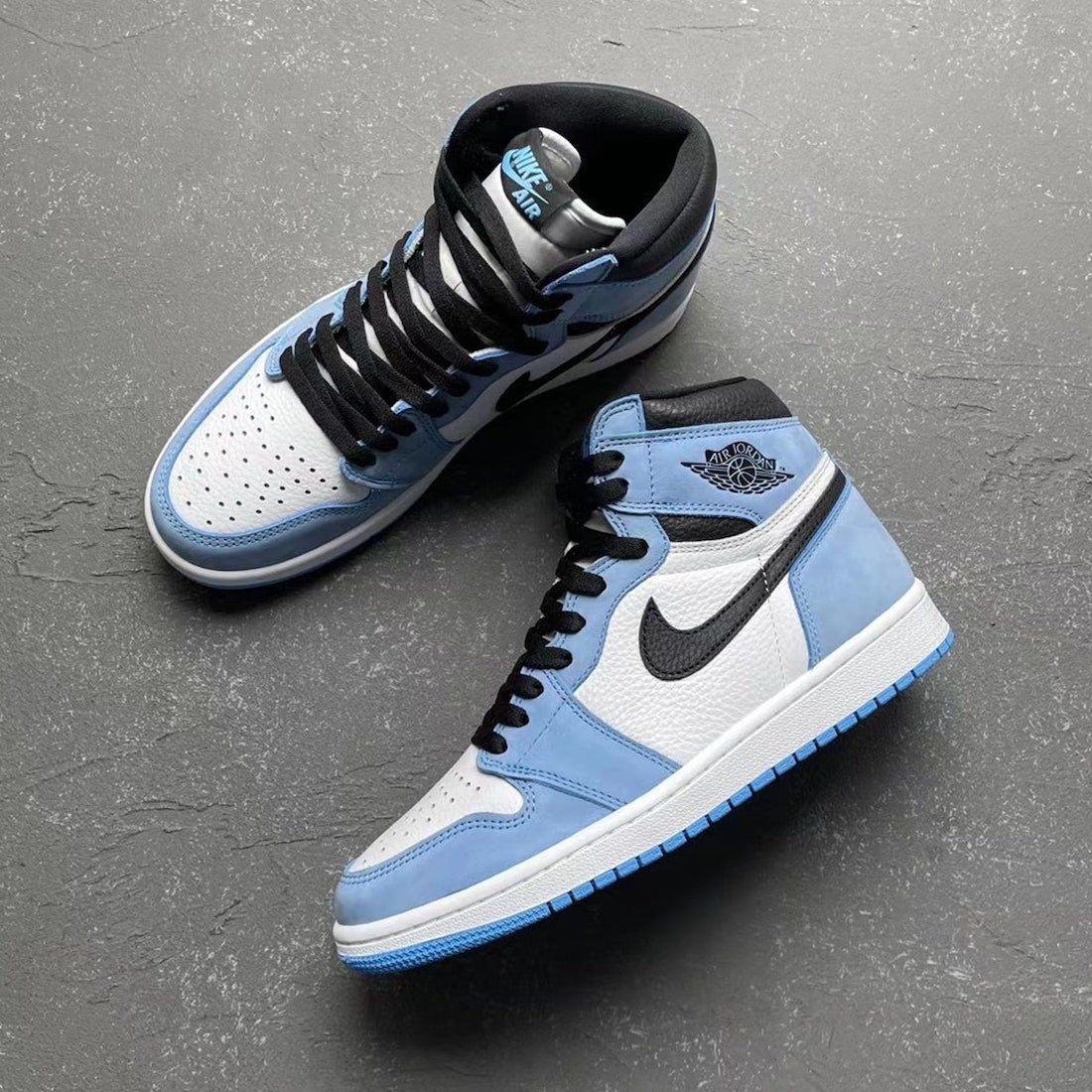 A pair of Air Jordan 1 High OG shoes are shown in a light blue and black colorway. - Air Jordan, Air Jordan 5