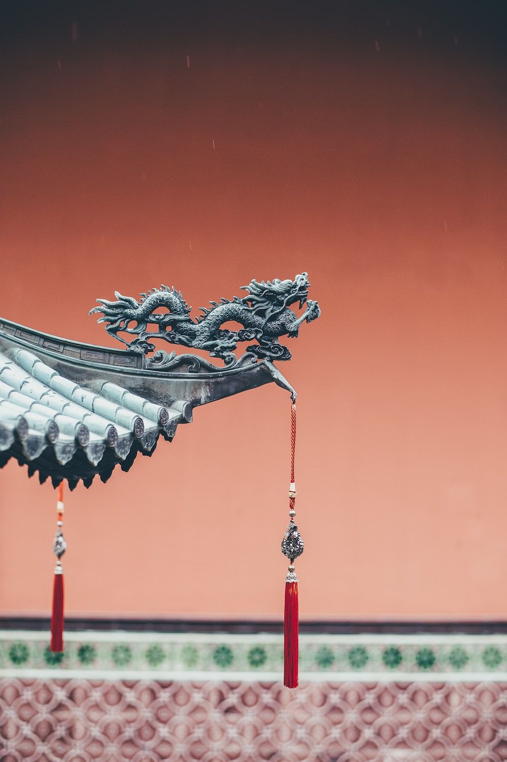 A dragon statue on the roof of a Chinese temple. - Chinese