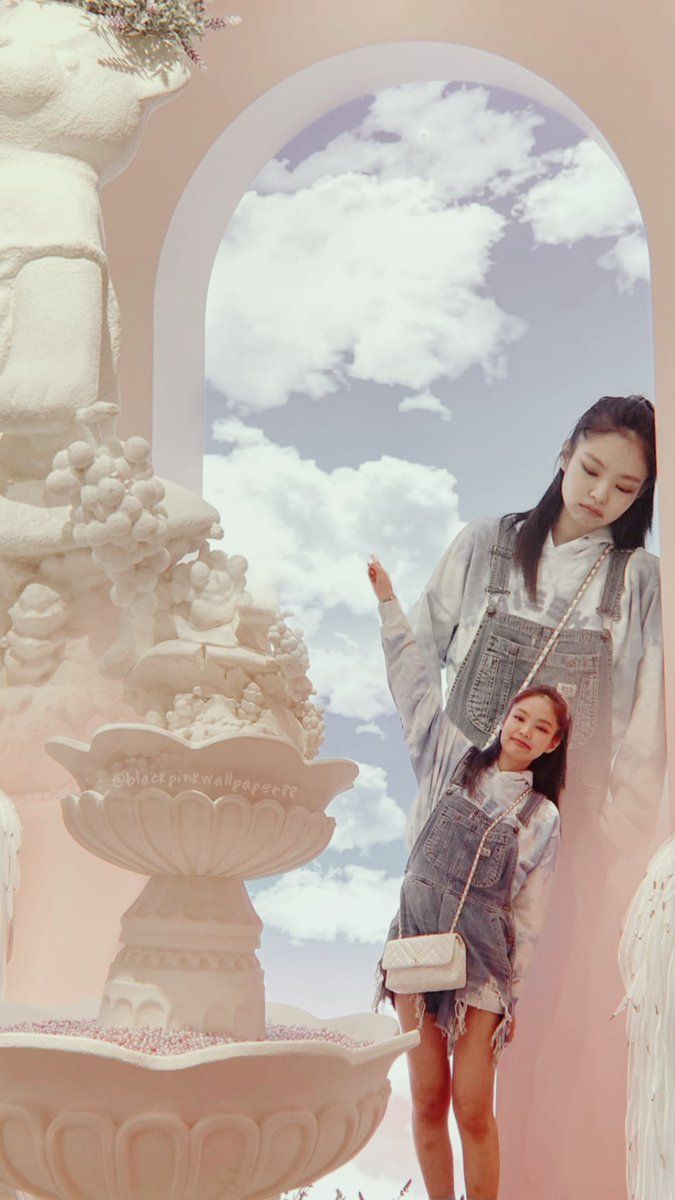 A woman and a child standing in front of a fountain - Jennie