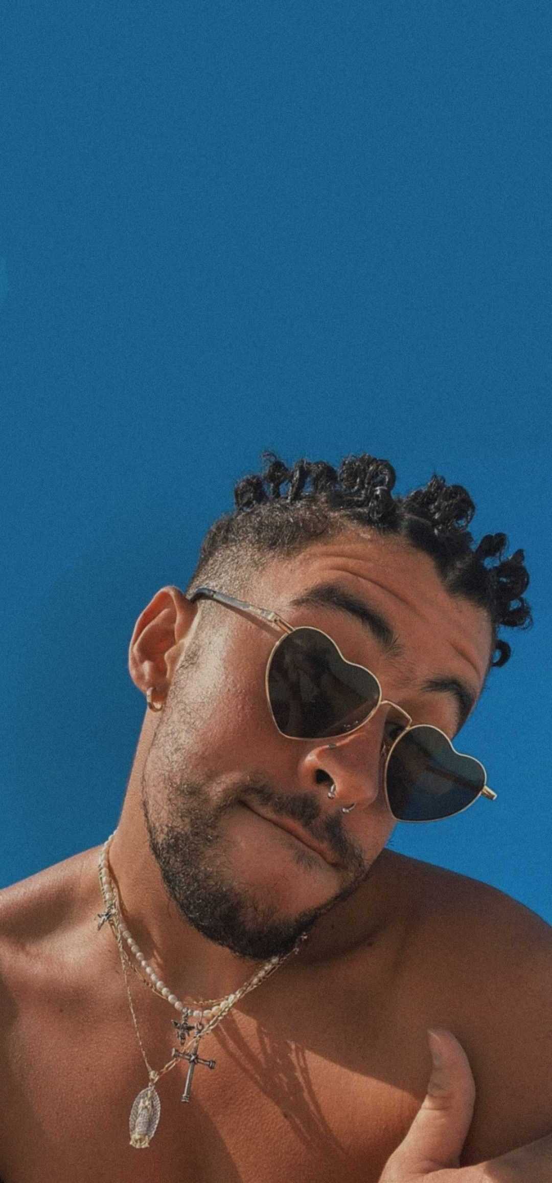 A man in sunglasses and shirtless - Bad Bunny